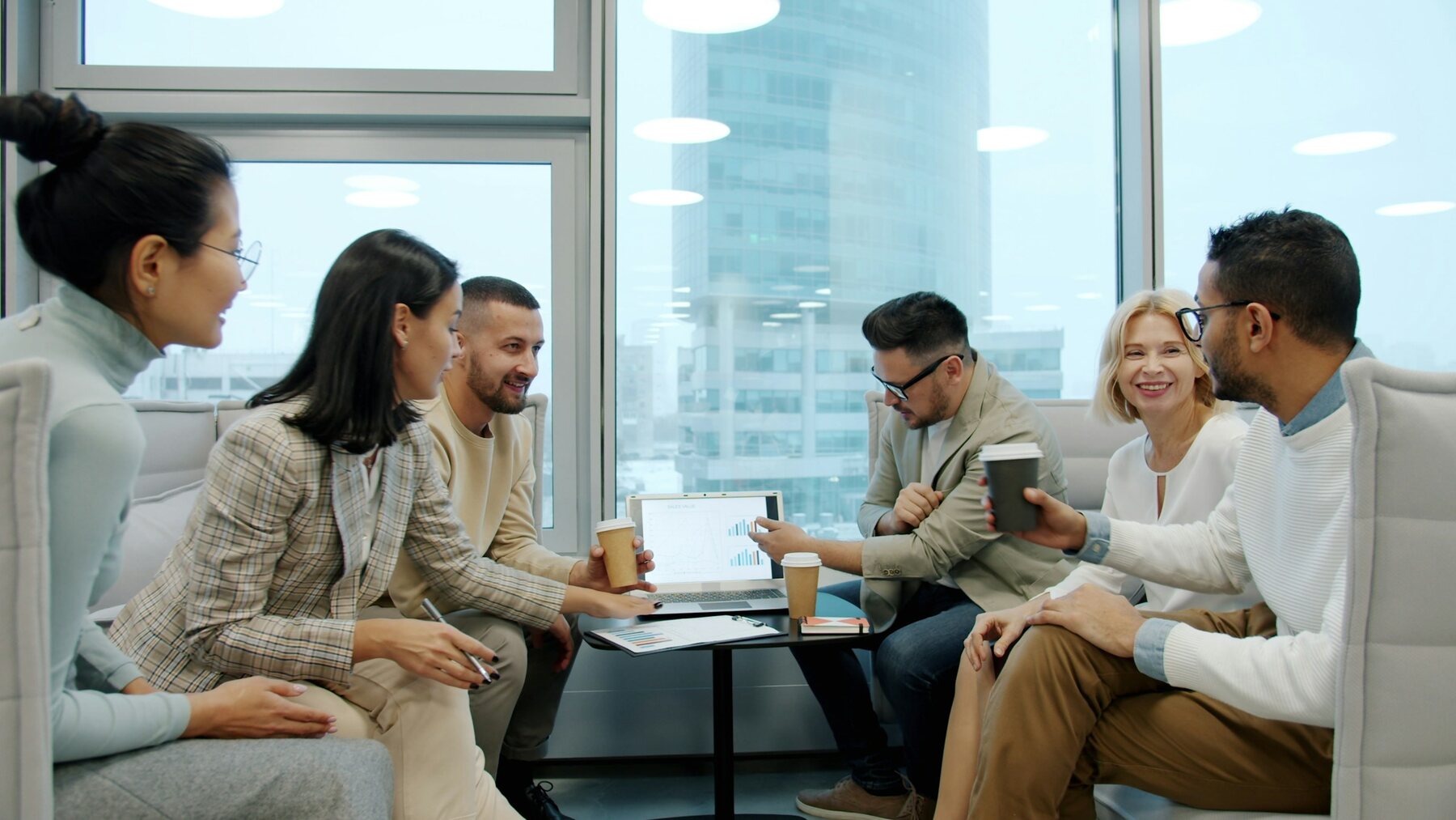 Business operations team collaborating around a table in a modern meeting space